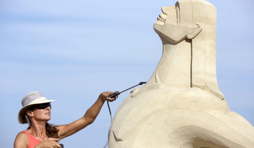 Marianne van den Broek, of Key West, Fla., works on her sculpture at the Revere Beach International Sand Sculpting Festival, Friday, July 21, 2017, in Revere, Mass. The festival runs though Sunday. (AP Photo/Michael Dwyer)