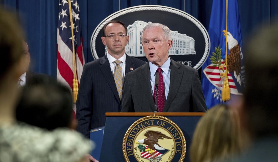 Attorney General Jeff Sessions accompanied by Deputy Attorney General Rod Rosenstein, left, speaks at a news conference to announce an international cybercrime enforcement action at the Department of Justice, Thursday, July 20, 2017, in Washington. (AP Photo/Andrew Harnik)