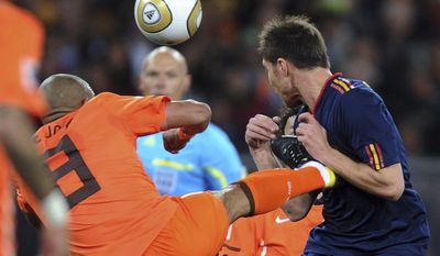 FILE - In this Sunday, July 11, 2010, file photo, Netherlands&#39; Nigel de Jong, left, fouls Spain&#39;s Xabi Alonso during the World Cup final soccer match at Soccer City in Johannesburg, South Africa. Howard Webb says he would have given De Jong a red card in the 2010 World Cup final if a video assistant referee had been in place.The retired English referee showed De Jong a yellow card in the 28th minute for his karate kick into the chest of Alonso. (AP Photo/Daniel Ochoa de Olza, File)