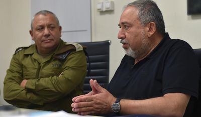 This handout photo provided by the Israeli military on Saturday, July 22, 2017, shows  Israel&#x27;s defense minister, Avigdor Lieberman talking to army chief Lt. Gen. Gadi Eizenkot at an Israeli military base in the West Bank. Israel has sent more troops to the West Bank. This comes a day after a Palestinian stabbed to death three members of an Israeli family in their home and after widespread Israeli-Palestinian clashes erupted over escalating tensions at the Holy Land&#x27;s most contested shrine.  (Israeli military via AP)