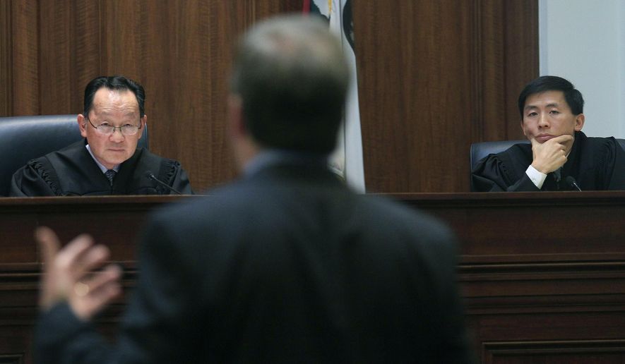 FILE - In this Nov. 10, 2011, file photo, Justice Ming Chin, left, and Justice Goodwin Liu, right, listen as Ross Moody of the San Francisco office of the Attorney General, center, speaks during a proceeding at the California Supreme Court in San Francisco. A California mom's legal battle over custody of her out-of-control daughter is raising questions about the best way to deal with wayward children. The California Supreme Court ruled Thursday, July 20, 2017, that if children face substantial danger, the state can take custody of them even if the parents are trying to keep them safe. In Thursday’s ruling, Chin said a delinquency finding “may follow the minor throughout his or her life, ” while Liu acknowledged finding that a parent is inadequate, “even when the parent is not at fault, can carry a painful stigma.” (AP Photo/Jeff Chiu/Pool, File)