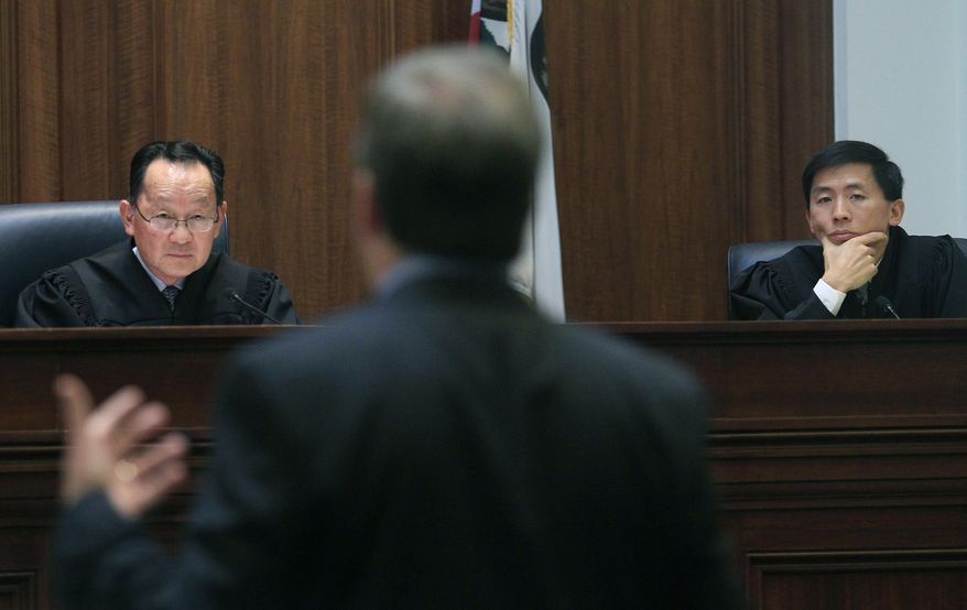 FILE - In this Nov. 10, 2011, file photo, Justice Ming Chin, left, and Justice Goodwin Liu, right, listen as Ross Moody of the San Francisco office of the Attorney General, center, speaks during a proceeding at the California Supreme Court in San Francisco. A California mom's legal battle over custody of her out-of-control daughter is raising questions about the best way to deal with wayward children. The California Supreme Court ruled Thursday, July 20, 2017, that if children face substantial danger, the state can take custody of them even if the parents are trying to keep them safe. In Thursday’s ruling, Chin said a delinquency finding “may follow the minor throughout his or her life, ” while Liu acknowledged finding that a parent is inadequate, “even when the parent is not at fault, can carry a painful stigma.” (AP Photo/Jeff Chiu/Pool, File)