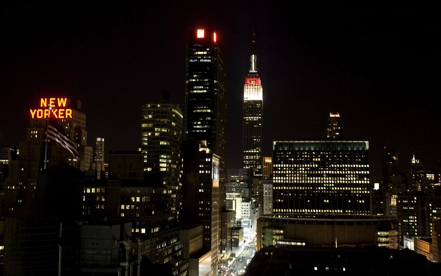 FILE - In this March 24, 2009 file photo, lights shine from high-rise buildings in New York. Across the United States, there is a mixed bag of laws on whether older high-rise apartment buildings must install fire sprinklers that weren't required when the towers were first built. Many cities _ including New York, Chicago, Dallas and San Francisco _ still have high-rises without the safety measure. Cost is often cited, but after the deadly July 14 fire in Honolulu, many question if the economics outweigh the potential for tragedy. (AP Photo/Caleb Jones, File)