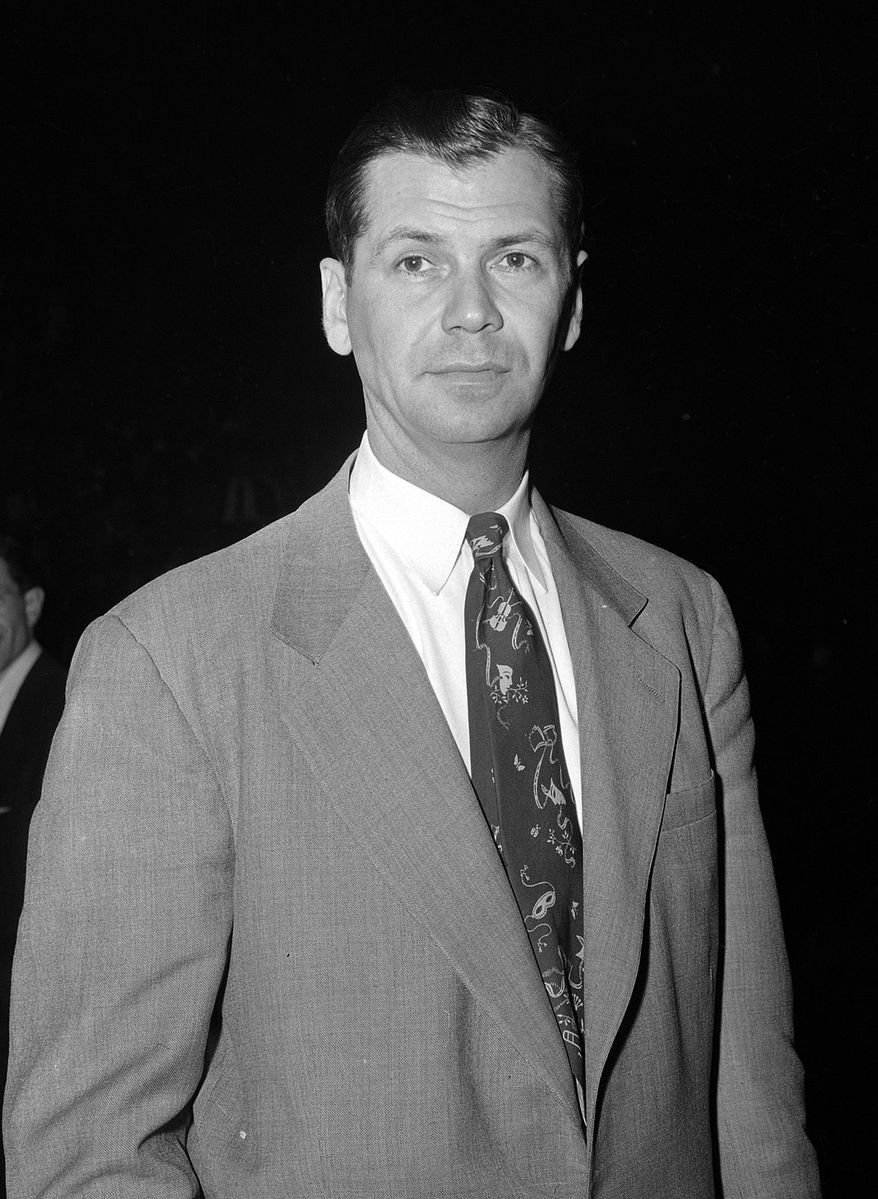 FILE - In this Feb. 23, 1954, file photo, John Kundla, coach of the Minneapolis Lakers, poses in New York. Hall of Fame coach Kundla died Sunday, July 23, 2017. He was 101. (AP Photo/Matty Zimmermann, File)