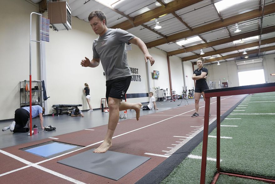 In this June 22, 2017, photo, lacrosse player Frankie Hattler performs a single leg dynamic stabilization landing test, which gives insight for the left side versus the right side of the body and can be used for later stages of returning to playing, as Sparta Science coach Kayla Sowinski watches in Menlo Park, Calif., Thursday, June 22, 2017. To keep players on the field instead of in the operating room and to maximize their ability when healthy, more and more pro and college sports teams are turning to technology. (AP Photo/Jeff Chiu)