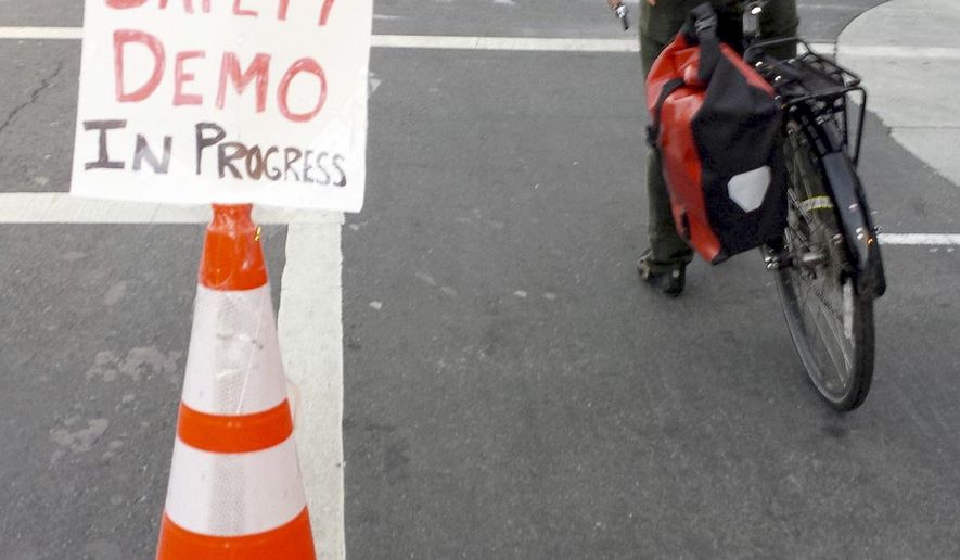 In this photo provided by the San Francisco Transformation Department, an orange cone separates cyclists from traffic on a San Francisco street on Monday, October 24, 2016. The divider was the work of the San Francisco Transformation Department, one of several like-minded groups of anonymous Twitter users who have taken a do-it-yourself approach to making road improvements in cities stretching from New York and Boston to Dallas. (Twitter via AP)