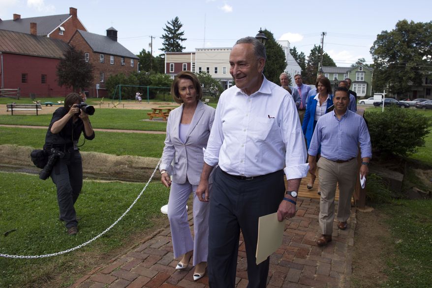 Senate Minority Leader Chuck Schumer of N.Y. and House Minority Leader Nancy Pelosi of Calif. lead Congressional Democrats to a news conference to unveil their new agenda, Monday, July 24, 2017, in Berryville, Va. House and Senate Democrats are offering a retooled message and populist agenda, promising to working Americans "someone has your back." (AP Photo/Cliff Owen)