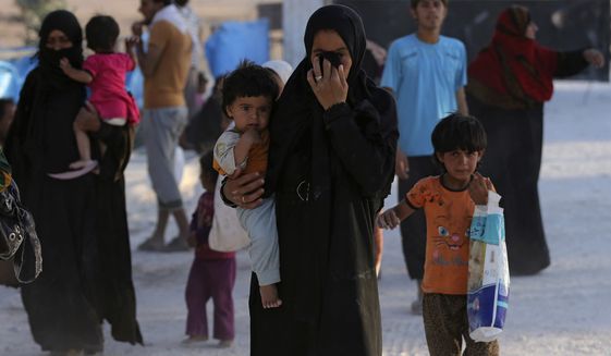 A Syrian displaced family that fled the battle between U.S.-backed Syrian Democratic Forces and the Islamic State militants from Raqqa arrive at a refugee camp in northeast Syria. The U.S. military is supporting local Syrian forces in a campaign to drive the Islamic State from Raqqa. (Associated Press)