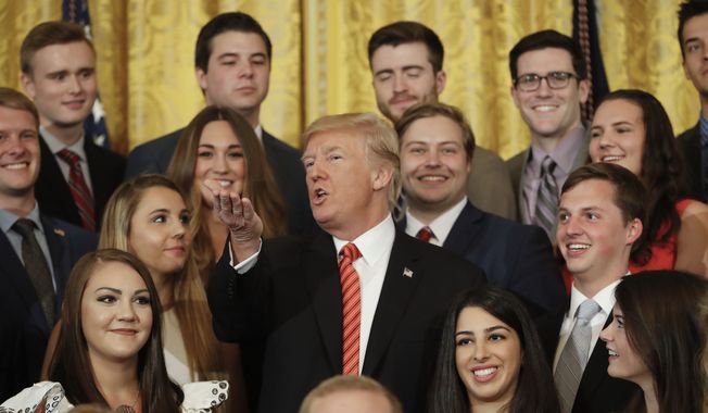 President Donald Trump speaks while posing for a photo with outgoing White House interns in the East Room of the White House in Washington, Monday, July 24, 2017. (AP Photo/Pablo Martinez Monsivais)