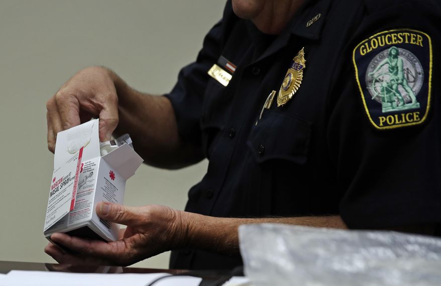 In this July 13, 2017 photo, Gloucester Police Chief John McCarthy opens a box containing NARCAN used to reverse an opioid overdose as he discusses a new Angel Program outreach plan that will be instituted with community advocates at the Police Assisted Addiction and Recovery Initiative, at the police station in Gloucester, Mass. Gloucester, like many other communities, is seeing more addicts overdosing on more potent varieties of the drug than it did when its amnesty program rocketed to national notoriety. The rising toll is prompting city officials to try new approaches. (AP Photo/Charles Krupa)