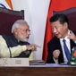 FILE - In this Oct. 16, 2016, file photo, Indian Prime Minister Narendra Modi, left, talks with Chinese President Xi Jinping at a signing ceremony by foreign ministers during the BRICS summit in Goa, India. India and China have faced off frequently since fighting a bloody 1962 war that ended with China seizing control of some territory. India’s army chief warned in July 2017 that India’s army was capable of fighting “2 1/2 wars” if needed to secure its borders. The dispute was discussed briefly without resolution by Xi and Modi on the sidelines of the G-20 summit in Hamburg, Germany. (AP Photo/Manish Swarup, File)