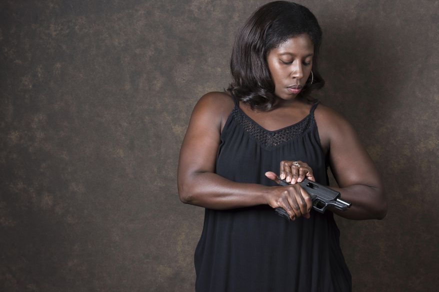 In this July 10, 2017, photo, Alicia Kelley poses for a portrait in Decatur, Ga., while checking the chamber on her handgun. Kelley is a 36-year-old banker who lives in Buford, Ga. She's among the ranks of the nation's black women who own firearms. "I fell in love with shooting at the range," she says. When she and her husband bought a home, they decided to buy a firearm for protection. "As times have changed, it's good to have home protection," she said of violence and the tension in today's unpredictable political climate. "It's so unpredictable. People used to hide behind the computer but now they're coming out. You don't know who you're going to run into. Nowadays people are acting before they're thinking." (AP Photo/Lisa Marie Pane)