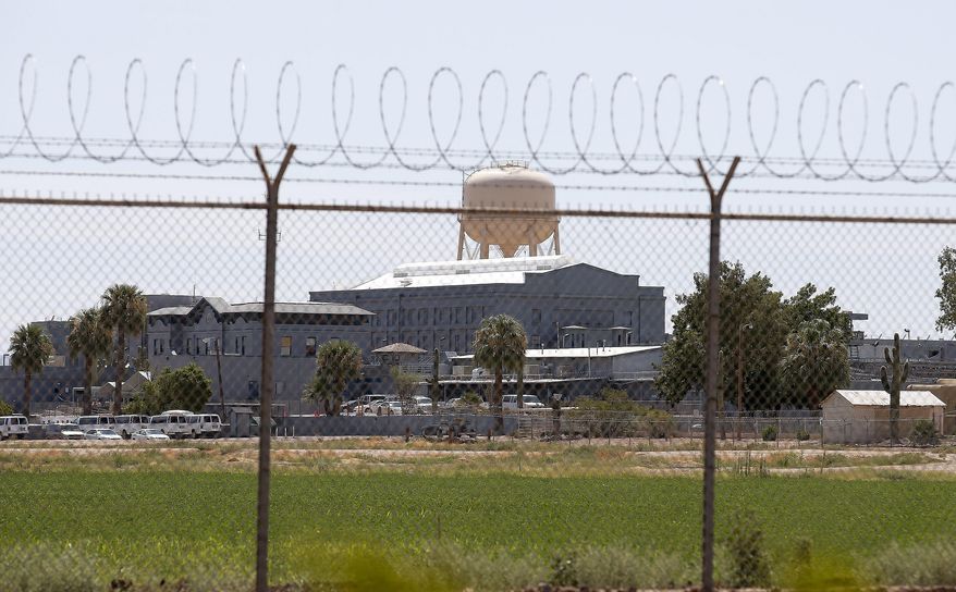 FILE - In this July 23, 2014, file photo, a fence surrounds the state prison in Florence, Ariz., where the execution of Joseph Rudolph Wood took place. A trial is scheduled to begin Tuesday, July 25, 2017, in which news organizations are seeking the source of lethal drugs used in Arizona's executions and the qualifications of those carrying out the death penalty. The lawsuit by The Associated Press and other news organizations was filed after the 2014 death of condemned prisoner Joseph Rudulph Wood, who was given 15 doses of a two-drug combination before he died. (AP Photo/File)