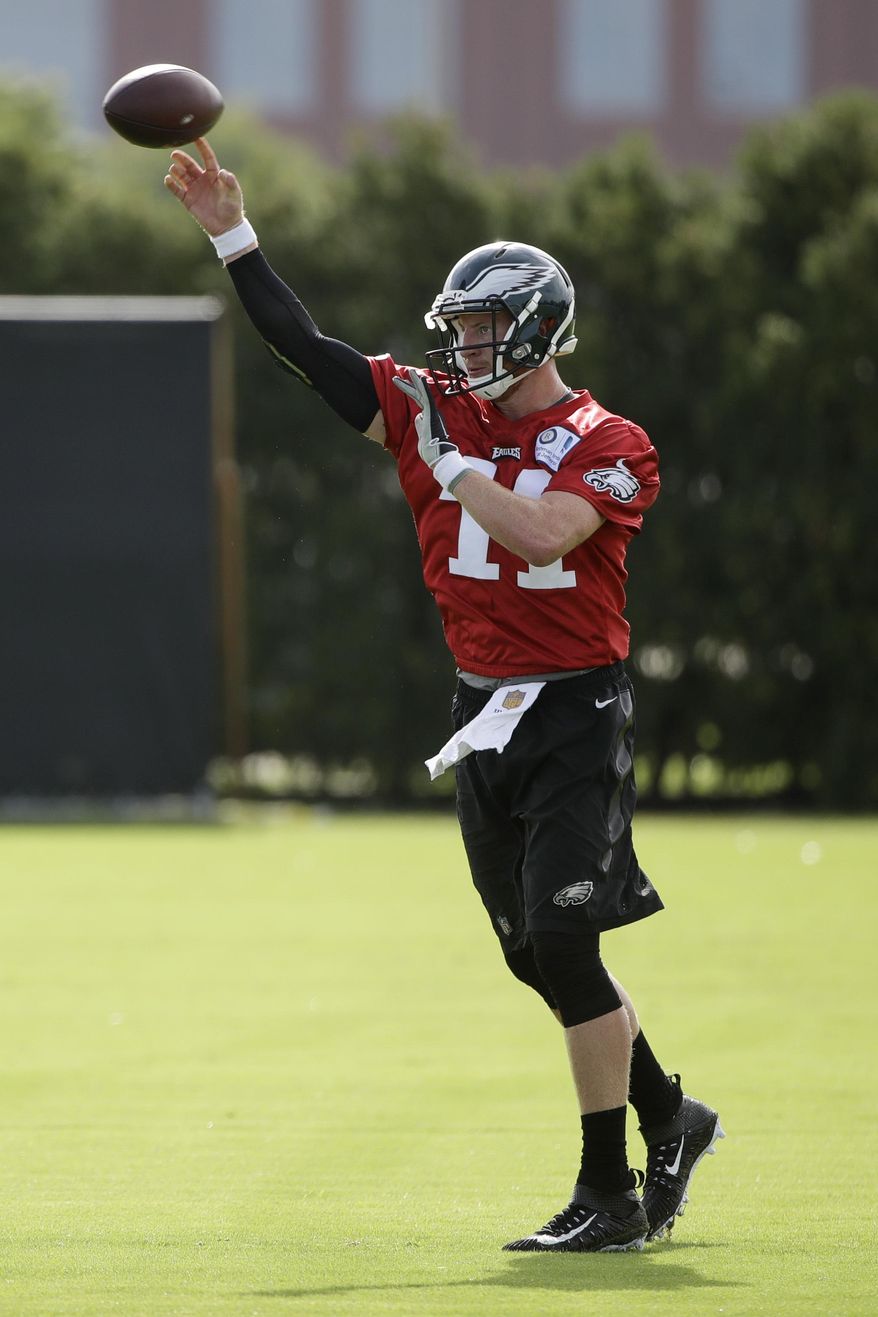 Philadelphia Eagles quarterback Carson Wentz throws a pass during an NFL football training camp in Philadelphia, Monday, July 24, 2017. (AP Photo/Matt Rourke)