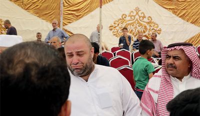 Zakaria al-Jawadah, center left, the father of Mohammed Mohammed al-Jawawdeh, a 17-year-old Jordanian, who was killed on Sunday evening by an Israeli security guard who said he was attacked by him with a screwdriver, cries at a funeral tent in Amman, Jordan, Monday, July 24, 2017. The deadly shooting, that killed  two Jordanians at a residential building used by Israeli embassy staff in Jordan, has further complicated Israeli government efforts to find a way out of an escalating crisis over the Holy Land&#39;s most contested shrine. (AP Photo/Reem Saad)