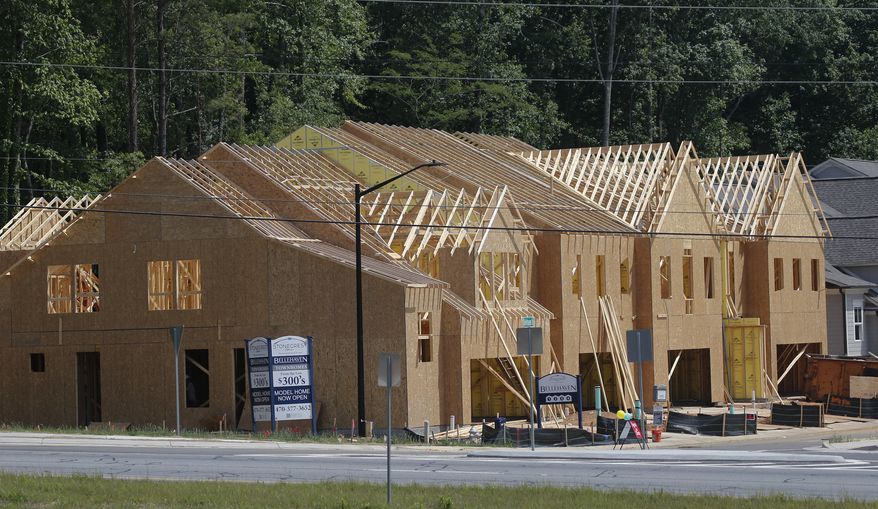This Tuesday, May 16, 2017, photo shows new town homes under construction in Woodstock, Ga. The Standard & Poor's/Case-Shiller 20-city home price index for May is released, Tuesday, July 25, 2017. (AP Photo/John Bazemore)