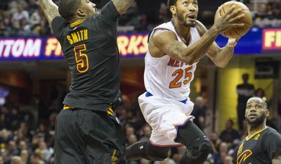 FILE - In this Oct. 25, 2016, file photo, New York Knicks&#x27; Derrick Rose (25) drives past Cleveland Cavaliers&#x27; J.R. Smith (5) as the Cavaliers LeBron James watches during the first half of an NBA basketball game in Cleveland. The Cleveland Cavaliers have signed free agent guard Derrick Rose to a 1-year contract. The team announced the deal on Tuesday, July 25, 2017, a day after the sides agreed that Rose will play for the veteran’s minimum of $2.1 million next season.(AP Photo/Phil Long, File)
