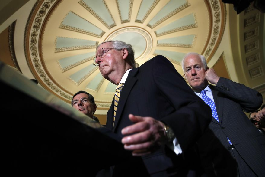 Senate Majority Leader Mitch McConnell of Ky., center, with Senate Majority Whip Sen. John Cornyn, R-Texas, right, and Sen. John Barrasso, R-Wyo., left, talks to reporters on Capitol Hill in Washington, Tuesday, July 25, 2017, after Vice President Mike Pence broke a 50-50 tie to start debating Republican legislation to tear down much of the Obama health care law. (AP Photo/Jacquelyn Martin)