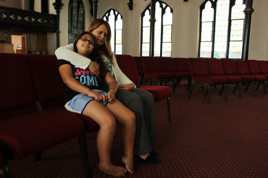 Nury Chavarria, 43, poses with her 9-year-old daughter, Hayley inside Iglesia De Dios Pentecostal church in New Haven, Conn., on Monday, July 24, 2017. Chavarria has sought sanctuary from deportation because she needs to be with her four children, and understands she has become a symbol in the larger fight over immigration reform. (AP Photo/Pat Eaton-Robb)