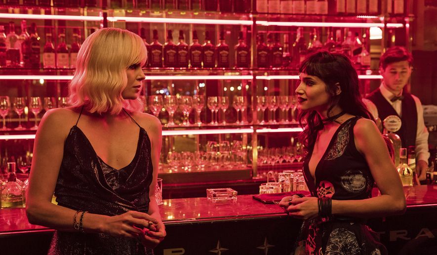 This image released by Focus Features shows Charlize Theron, left, and Sofia Boutella in "Atomic Blonde." (Jonathan Prime/Focus Features via AP)