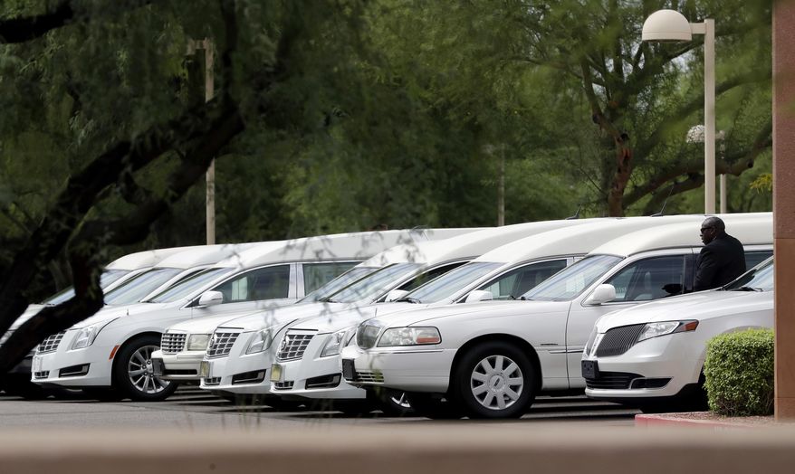 Hearses of the family members who were killed in a flash flood are parked outside St. Patrick church, Tuesday, July 25, 2017, in Scottsdale, Ariz. Ten members of an extended Arizona family were killed earlier this month in flash flood while they celebrated a birthday are being remembered as hard-working immigrants from Mexico trying to provide a better life for their children. (AP Photo/Matt York)