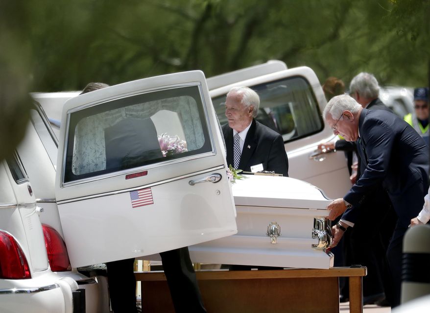 The caskets of family members who were killed in a flash flood are loaded into hearses outside St. Patrick Catholic Church, Tuesday, July 25, 2017, in Scottsdale, Ariz. Ten members of an extended Arizona family were killed earlier this month in flash flood while they celebrated a birthday. (AP Photo/Matt York)