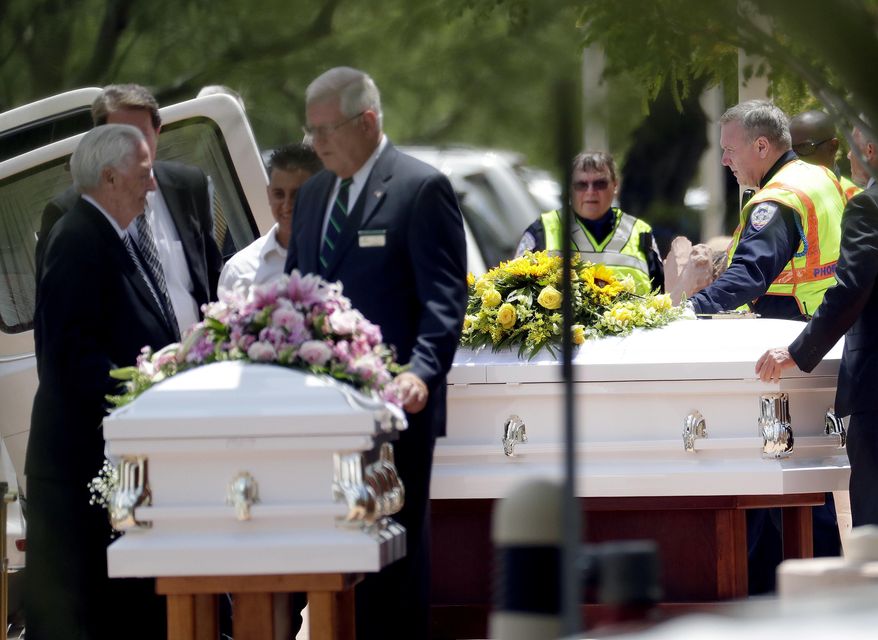 The caskets of family members who were killed in a flash flood are loaded into hearses outside St. Patrick Catholic Church, Tuesday, July 25, 2017, in Scottsdale, Ariz. Ten members of an extended Arizona family were killed earlier this month in flash flood while they celebrated a birthday. (AP Photo/Matt York)