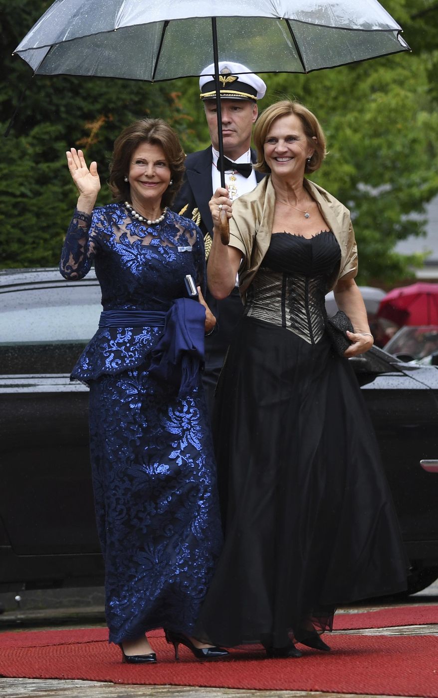 Queen Silvia of Sweden, left, and the wife of Bavarian governor Karin Seehofer, right, arrive for the opening of the opera festival in Bayreuth, Germany, Tuesday, July 25, 2017. The Richard Wagner Festival will be opened with the opera "The Master-Singers of Nuremberg". (Tobias Hase/dpa via AP)