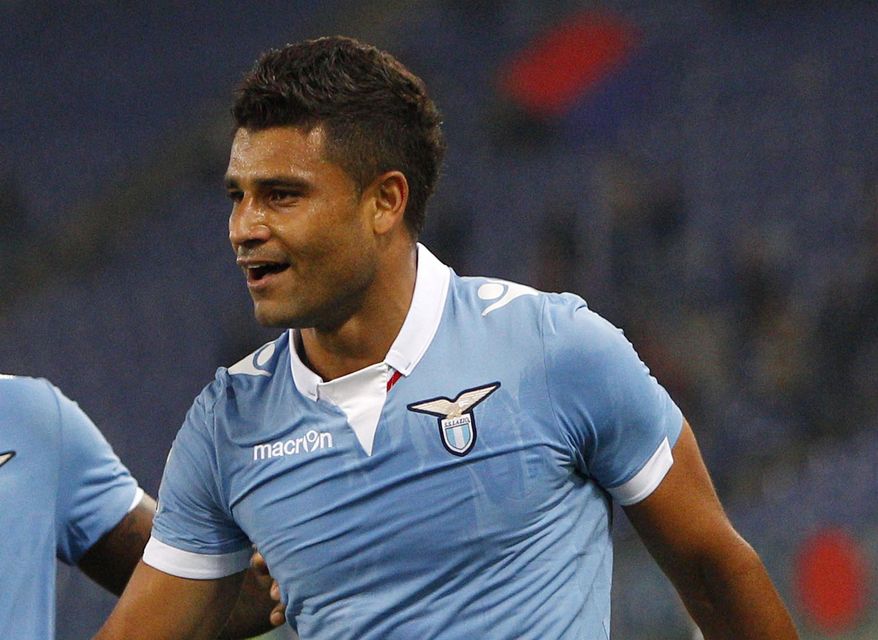 FILE- In this Monday, Nov. 3, 2014 file photo, Lazio's Ederson celebrates with teammates after scoring during a Serie A soccer match between Lazio and Cagliari, at Rome's Olympic stadium. One-time Brazil midfielder Ederson says he has testicular cancer and won't be able to play for his Flamengo club for months. (AP Photo/Riccardo De Luca, File)