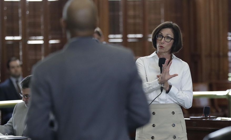 State Sen. Lois Kolkhorst, R-Brenham, right, speaks to Sen. Borris Miles, D-Houston, left, during debate over a "bathroom bill" in the Senate Chamber, Tuesday, July 25, 2017, in Austin, Texas. The Texas Senate has revived a bill mandating transgender Texans use public restrooms corresponding to their birth-certificate genders. (AP Photo/Eric Gay)
