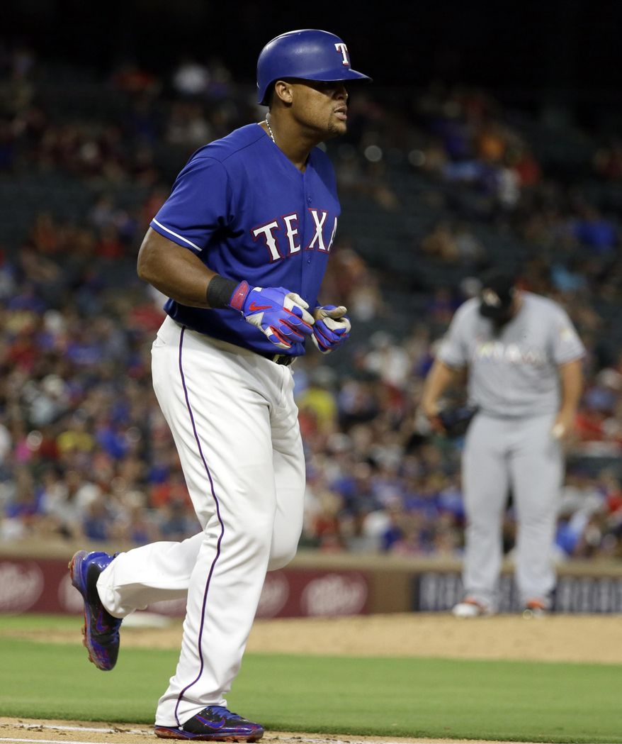 Texas Rangers' Adrian Beltre jogs to first after earning a walk from Miami Marlins relief pitcher Hunter Cervenka, rear, during the fifth inning of a baseball game, Tuesday, July 25, 2017, in Arlington, Texas. (AP Photo/Tony Gutierrez)
