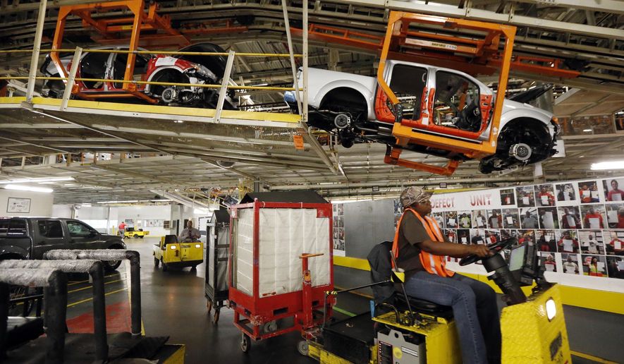 FILE - In this April 6, 2016, file photograph, vehicles are suspended above other installation stations as they are moved along the assembly line at the Nissan Canton Vehicle Assembly Plant in Canton, Miss. A bid by workers at Mississippi&#x27;s Nissan Motor Co. plant for United Auto Workers representation could turn on a key voting bloc: the 1,500 Nissan employees who were initially hired through contract labor agencies. (AP Photo/Rogelio V. Solis, File)