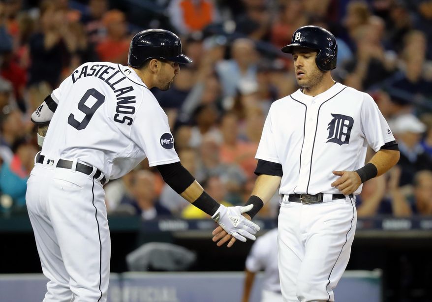 Detroit Tigers' Ian Kinsler, right, celebrates after scoring with Nicholas Castellanos (9) on a Miguel Cabrera (24) single against the Kansas City Royals in the sixth inning of a baseball game in Detroit, Monday, July 24, 2017. (AP Photo/Paul Sancya)