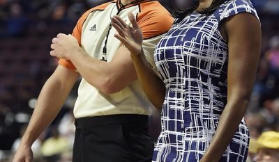 Chicago Sky coach Amber Stocks discusses a call with official J.B. DeRosa during play against the Connecticut Sun in a WNBA basketball game Tuesday, July 25, 2017, in Uncasville, Conn. (Sean D. Elliot/The Day via AP)