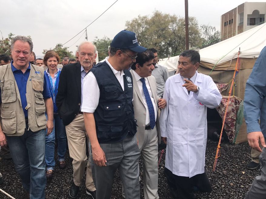 Dr. Tedros Adhanom Ghebreyesus, director general, WHO (center), listens to the head doctor of Al-Sabeen Hospital in Sanaa, Yemen. (Courtesy WHO) ** FILE **