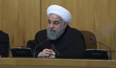 In this photo released by official website of the office of the Iranian Presidency, Iran&#39;s President Hassan Rouhani speaks in a cabinet meeting in Tehran, Iran, Wednesday, July 26, 2017. Iran&#39;s President Hassan Rouhani says his country will respond if U.S. legislation imposing sanctions on people involved in Iran&#39;s ballistic missile program becomes law. (Iranian Presidency Office via AP)
