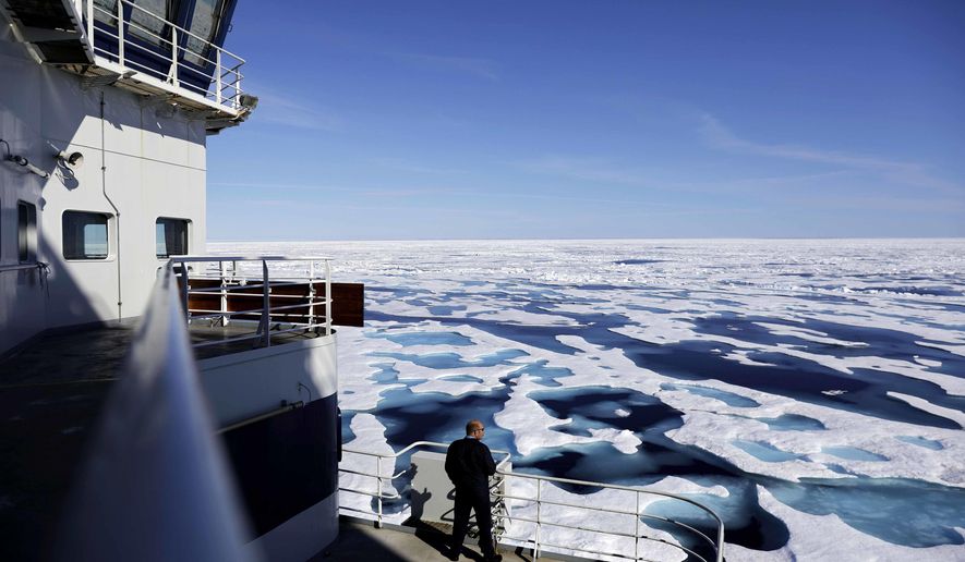 In this Saturday, July 22, 2017 photo, Canadian Coast Guard Capt. Victor Gronmyr looks out over the ice covering the Victoria Strait as the Finnish icebreaker MSV Nordica traverses the Northwest Passage through the Canadian Arctic Archipelago. (AP Photo/David Goldman)