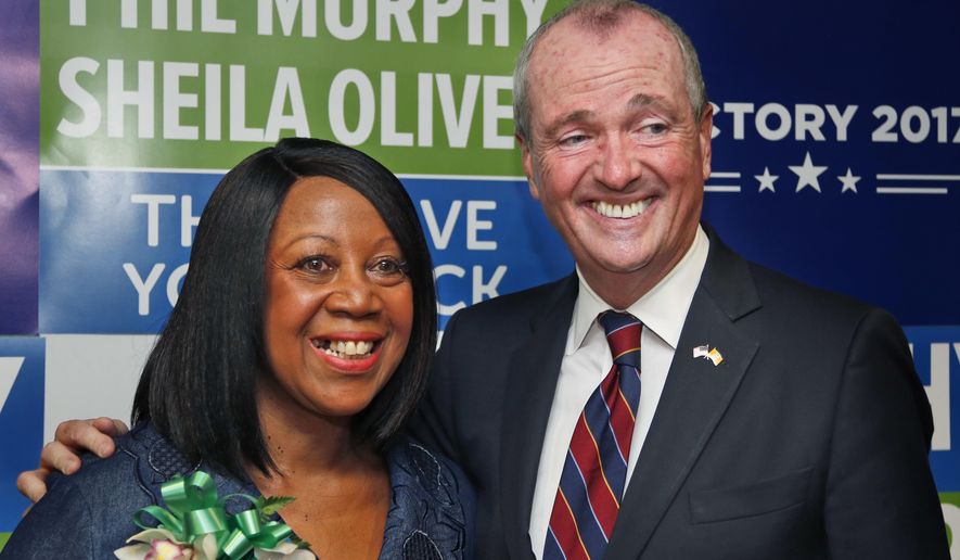 Democratic candidate for New Jersey governor Phil Murphy poses for pictures with the candidate for lieutenant governor, Sheila Oliver, during a news conference in Newark, N.J., Wednesday, July 26, 2017. Murphy announced that Assemblywoman Oliver is joining his ticket as the candidate for lieutenant governor. (AP Photo/Seth Wenig)