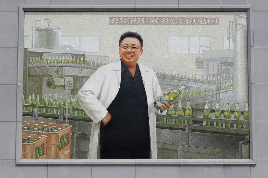 In this Wednesday, July 26, 2017, photo, a mural of the late North Korean leader Kim Jong Il in a white lab coat holding up a bottle of beer is seen at the entrance of the Taedonggang Brewery in Pyongyang, North Korea. Taedonggang beers are generally reputed to be world-class, which is a matter of national pride among many North Koreans. (AP Photo/Wong Maye-E)