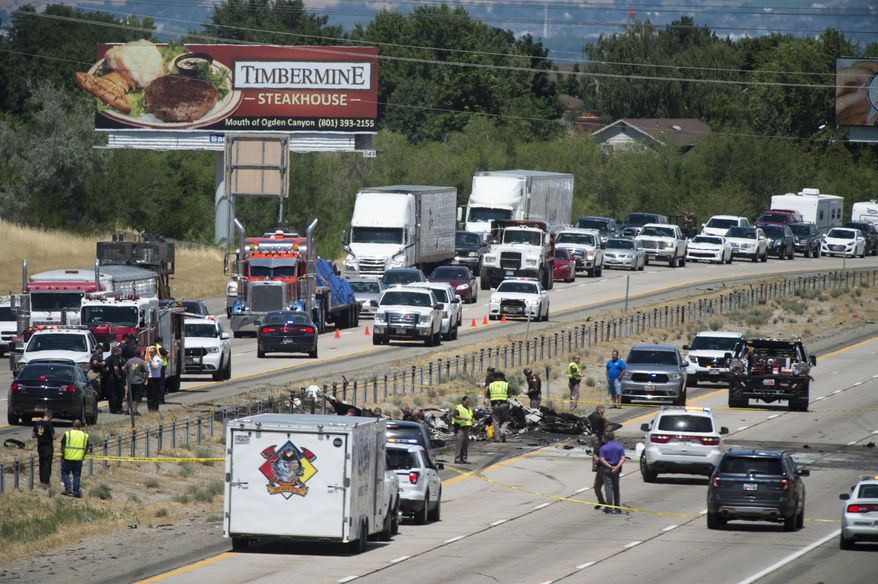 Four people died when their small plane crashed in the middle of I-15 near Riverdale, Utah, Wednesday, July 26, 2017. The crash closed the freeway to northbound traffic. (Rick Egan/The Salt Lake Tribune via AP)