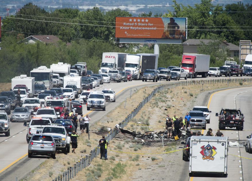 Four people died when their small plane crashed in the middle of I-15 near Riverdale, Utah, Wednesday, July 26, 2017. The crash closed the freeway to northbound traffic. (Rick Egan/The Salt Lake Tribune via AP)