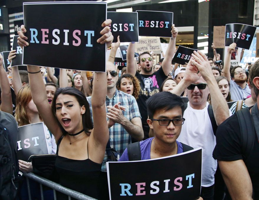 Protestors react as New York City Public Advocate Letitia James speaks during a rally in Times Square, Wednesday, July 26, 2017, in New York. The rally was held in protest of President Donald Trump's announcement of a ban on transgender troops serving anywhere in the U.S. military. (AP Photo/Frank Franklin II)