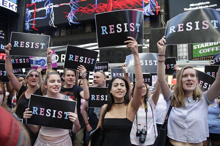 Protestors gather in Times Square, Wednesday, July 26, 2017, in New York. A rally was held in Times Square after President Donald Trump's announcement of a ban on transgender troops serving anywhere in the U.S. military. (AP Photo/Frank Franklin II)