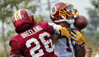 Washington Redskins cornerback Bashaud Breeland (26) breaks up a pass intended for wide receiver Josh Doctson (18) during NFL football training camp in Richmond,. Va., Thursday, July 27, 2017. (AP Photo/Steve Helber)