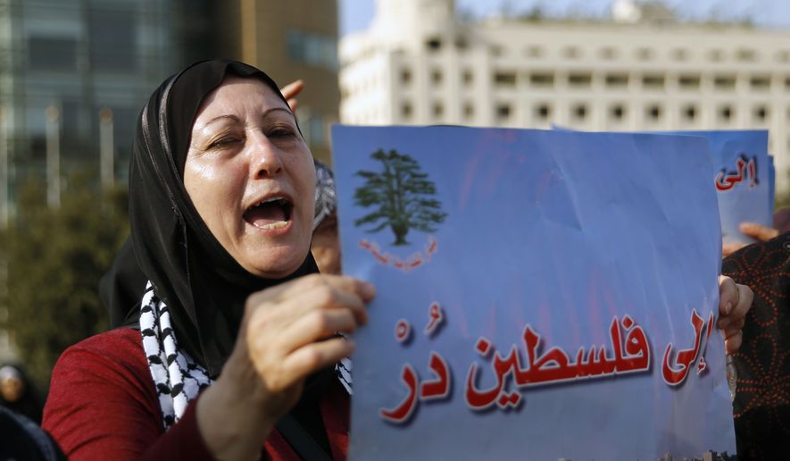 A Palestinian living in Lebanon chants slogans as she holds a placard with Arabic read ing, &quot;turn toward Palestine,&quot; during a sit-in in support of Palestinians and the Jerusalem holy site of Al Aqsa Mosque, in front of the United Nations Headquarters in Beirut, Lebanon, Thursday, July 20, 2017. (AP Photo/Bilal Hussein)