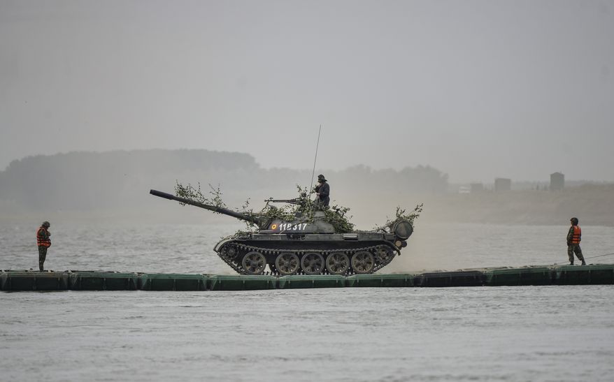 A Romanian army tank maneuvers on a pontoon bridge on Borcea tributary to the Danube river during the Saber Guardian 17 joint military exercise with US troops, in Bordusani, Ialomita, Romania, Sunday, July 16, 2017. The Saber Guardian 17 exercises led by U.S. Army Europe began this week in Eastern Europe involving 25,000 military personnel from more than 20 allied and partner countries. (AP Photo/Andreea Alexandru)