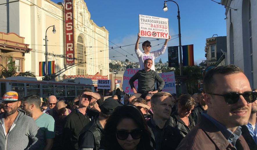 Protesters listen to speakers at a demonstration against a proposed ban of transgendered people in the military in the Castro District, Wednesday, July 26, 2017, in San Francisco. Demonstrators flocked to a plaza named for San Francisco gay-rights icon Harvey Milk to protest President Donald Trumps abrupt ban on transgender troops in the military. (AP Photo/Olga R. Rodriguez)