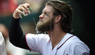 Washington Nationals&#39; Bryce Harper douses himself with water in the dugout before a baseball game against the Milwaukee Brewers, Thursday, July 27, 2017, in Washington. (AP Photo/Nick Wass)