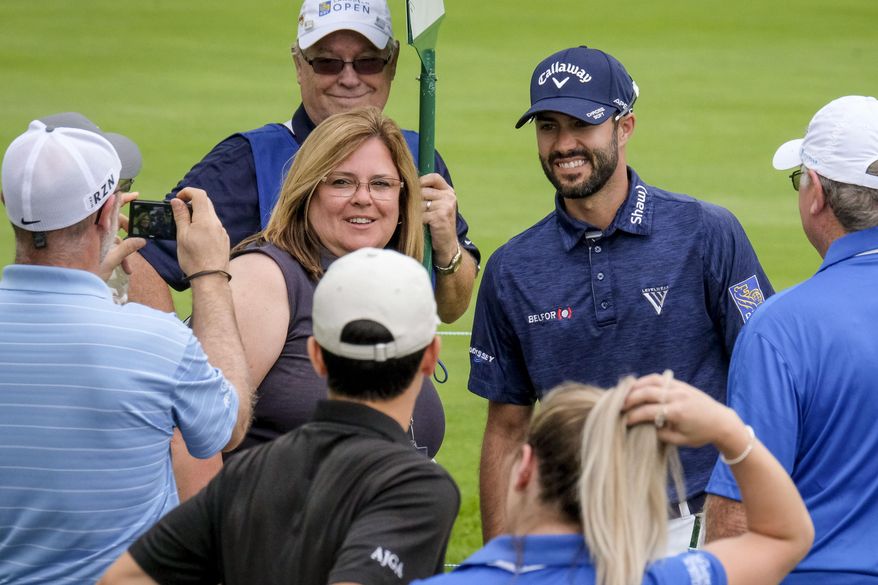 Adam Hadwin, of Abbotsford ritish Columbia, poses for pictures with fans on his way the the 17th tee during the Canadian Open Pro-Am golf tournament in Oakville, Ontario, Wednesday July 26, 2017. (David Cooper/The Canadian Press via AP)