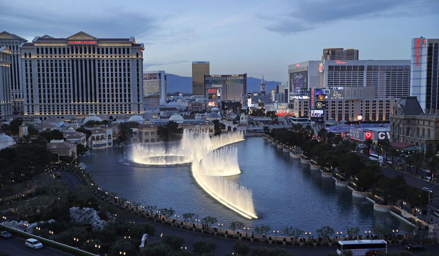 File - In this April 4, 2017, file photo, the fountains of Bellagio erupt along the Las Vegas Strip in Las Vegas. The Nevada Gaming Control Board reported Thursday, July 27, 2017, that casino gambling revenues totaled $895 million in June, up just under 1 percent statewide from the same month last year. (AP Photo/John Locher, File)